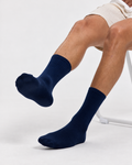 Base Supply navy ribbed crew socks worn by a seated model
