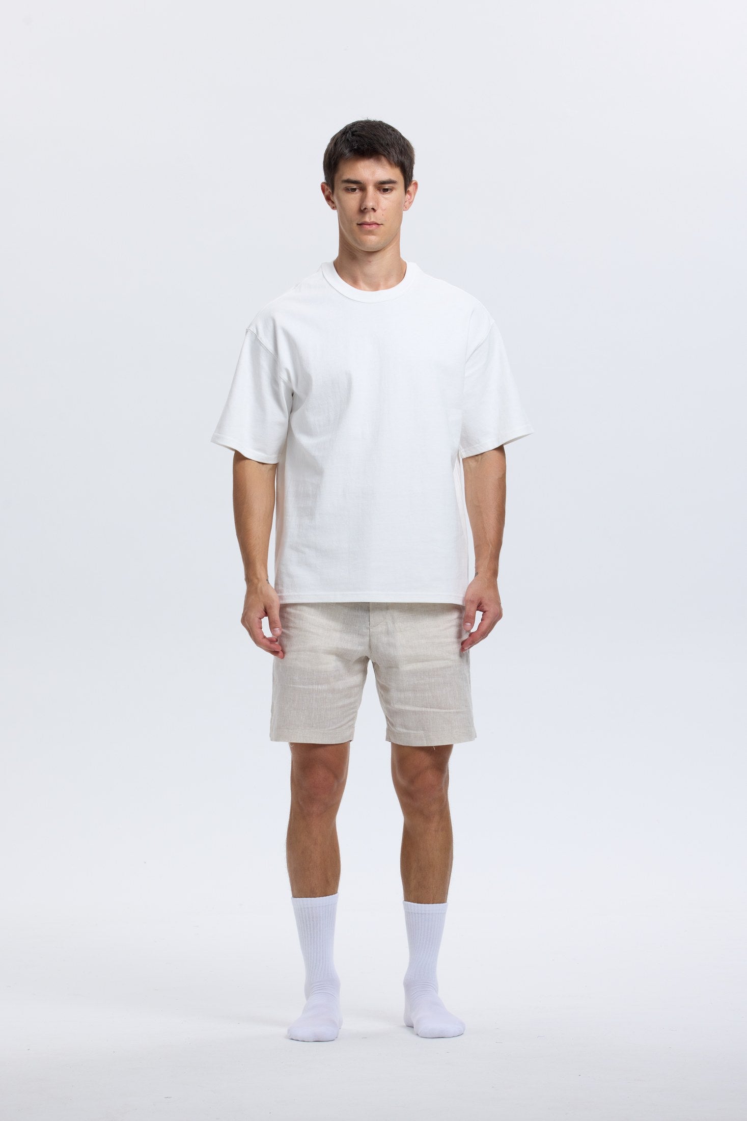 Full-body portrait of model wearing white Base Supply crew socks
