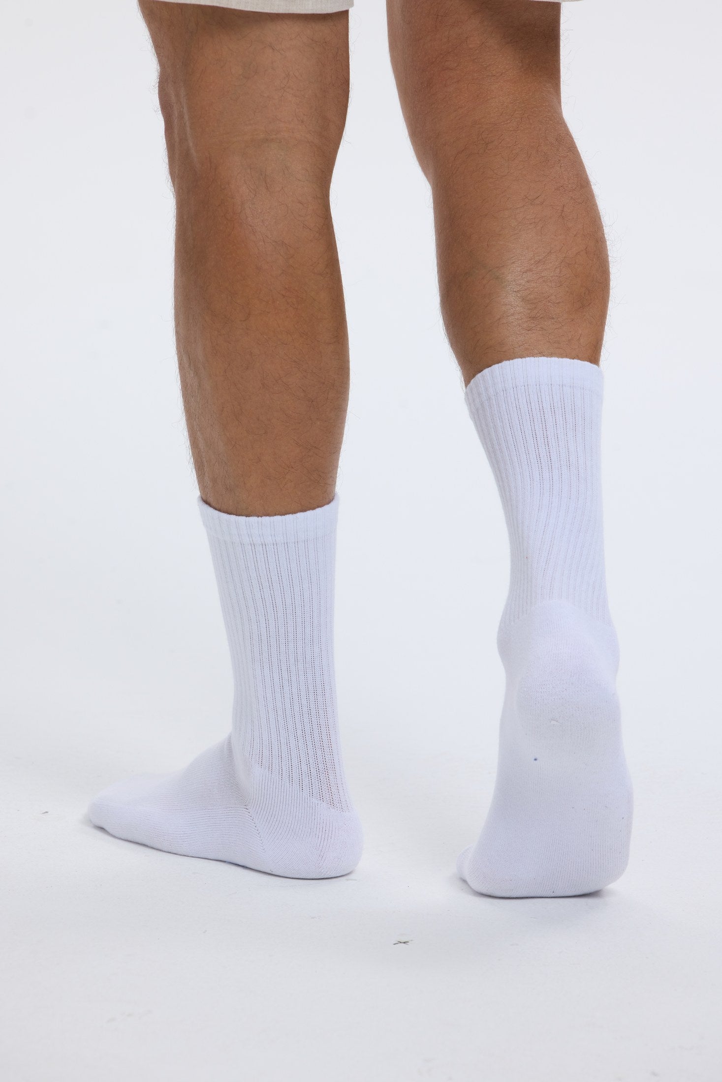 Close portrait of white Base Supply crew socks being worn