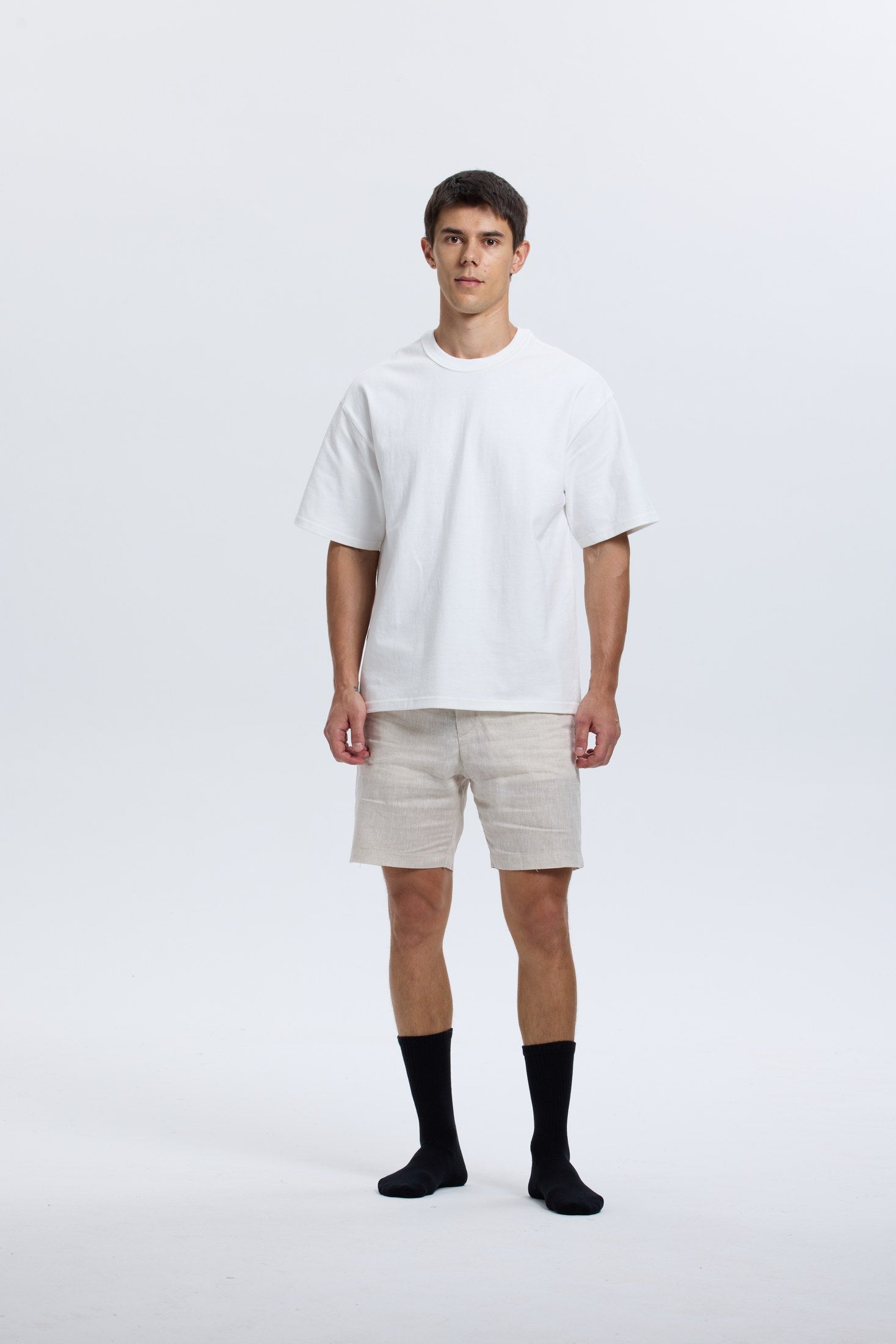 Full-body portrait of model wearing black Base Supply crew socks