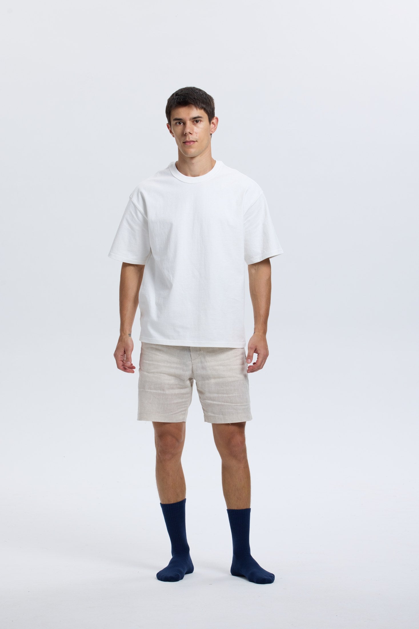 Full-body portrait of model wearing navy Base Supply crew socks
