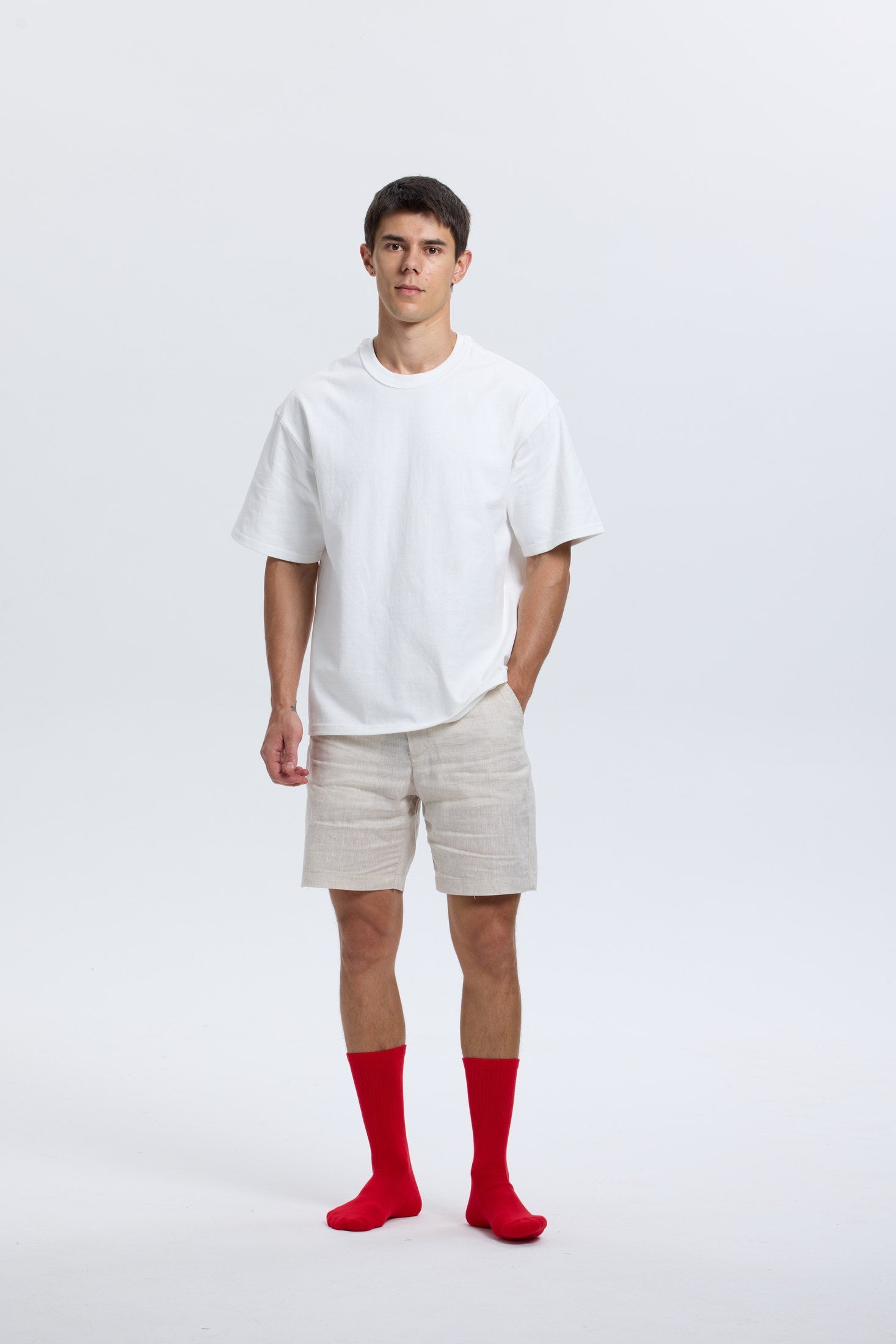 Full-body portrait of model wearing red Base Supply crew socks